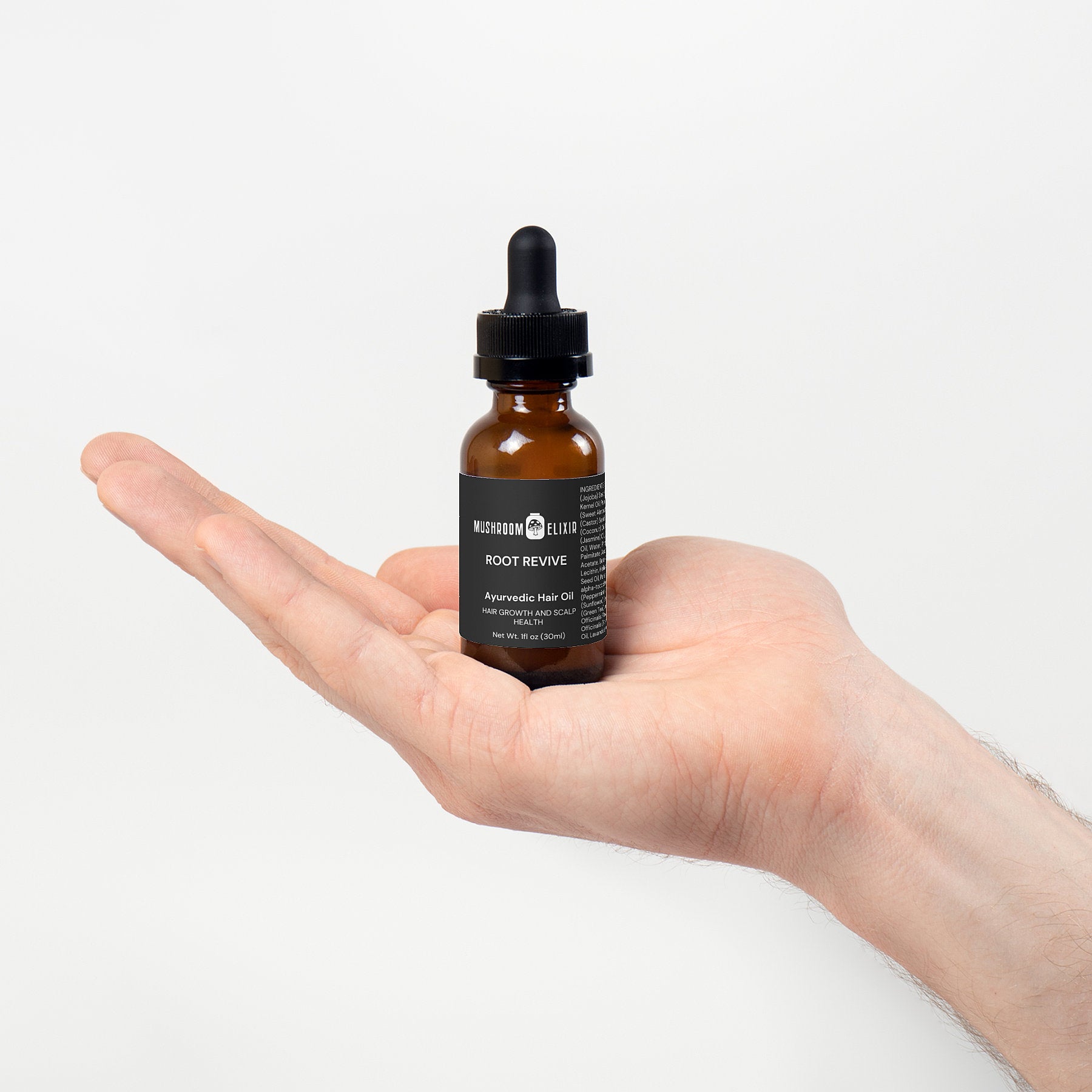 MushroomElixir Root Revive Hair Oil bottle detail showing Ayurvedic herbs